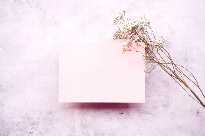 a pink paper with a bunch of flowers on top of it